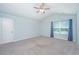Large carpeted bedroom with vaulted ceiling and a bright window with curtains at 3745 Sawmill Ct, Mount Pleasant, SC 29429