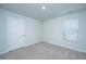 Empty bedroom features neutral carpet, white walls, window with blinds, and a door at 3745 Sawmill Ct, Mount Pleasant, SC 29429