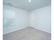 Empty bedroom features neutral carpet, white walls, window with blinds, and a door at 3745 Sawmill Ct, Mount Pleasant, SC 29429