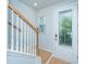 Entryway featuring a staircase with wood handrail and a front door with window at 3745 Sawmill Ct, Mount Pleasant, SC 29429