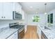 Bright kitchen boasts granite countertops, stainless steel appliances and hardwood flooring at 3745 Sawmill Ct, Mount Pleasant, SC 29429