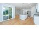 Open kitchen features island with a sink, stainless appliances, and sliding door access to screened porch at 3745 Sawmill Ct, Mount Pleasant, SC 29429