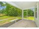 Comfortable screened patio with concrete flooring and views of the lush green backyard at 3745 Sawmill Ct, Mount Pleasant, SC 29429