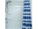Bathroom shower with blue patterned curtain, chrome faucet and shower head plus built-in shelving at 3745 Sawmill Ct, Mount Pleasant, SC 29429