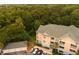An aerial view of the condo building and garages is surrounded by lush trees at 400 Bucksley Ln # 301, Charleston, SC 29492