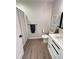 Modern bathroom featuring wood-look flooring and a white vanity with sleek black hardware at 400 Bucksley Ln # 301, Charleston, SC 29492