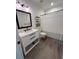 Modern bathroom featuring a white vanity with black accents and a shower with a white curtain at 400 Bucksley Ln # 301, Charleston, SC 29492