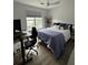 Cozy bedroom featuring a comfortable bed, workspace, and ample natural light from a large window at 400 Bucksley Ln # 301, Charleston, SC 29492