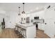 Bright kitchen with an island, bar stools and stainless steel appliances at 400 Bucksley Ln # 301, Charleston, SC 29492