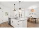 Bright, modern kitchen with white cabinets, quartz countertops, and stainless steel appliances, illuminated by pendant lighting at 400 Bucksley Ln # 301, Charleston, SC 29492