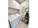 Functional laundry room with washer, dryer, storage cabinets, and practical cleaning amenities at 400 Bucksley Ln # 301, Charleston, SC 29492