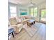Inviting living room with natural light, comfortable seating, ceiling fan, and access to the outdoor balcony at 400 Bucksley Ln # 301, Charleston, SC 29492
