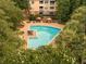 Overhead view of the inviting community pool and lounging area with lush surrounding landscaping at 400 Bucksley Ln # 301, Charleston, SC 29492