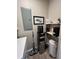 Compact utility area featuring a water dispenser, cleaning supplies, and practical storage solutions at 400 Bucksley Ln # 301, Charleston, SC 29492