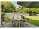 Inviting outdoor dining area with seating for six under a shade umbrella, perfect for al fresco meals at 429 Venning St, Mount Pleasant, SC 29464
