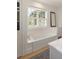 Bathroom featuring a soaking tub with white cabinets and lots of natural light at 429 Venning St, Mount Pleasant, SC 29464