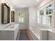 Bright bathroom featuring a modern soaking tub, dual sinks, and lots of natural light at 429 Venning St, Mount Pleasant, SC 29464