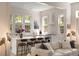 Bright, modern kitchen open to the living room, featuring a center island with seating and white cabinetry at 429 Venning St, Mount Pleasant, SC 29464
