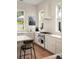 Well-lit kitchen with stainless steel appliances and white countertops, complemented by bar stool seating at 429 Venning St, Mount Pleasant, SC 29464