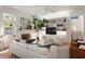 Inviting living room featuring hardwood floors, a fireplace, and an open layout with a modern kitchen at 429 Venning St, Mount Pleasant, SC 29464