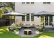 Charming patio area with comfortable seating, umbrellas, and lush greenery for outdoor relaxation and entertaining at 429 Venning St, Mount Pleasant, SC 29464