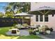 Charming patio area with comfortable seating, umbrellas, and lush greenery for outdoor relaxation and entertaining at 429 Venning St, Mount Pleasant, SC 29464