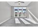 Spacious bedroom with gray carpet and large french doors that lead to outdoor balcony and offer ample natural light at 4587 Summey St, North Charleston, SC 29405