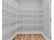 A large walk-in closet with wood floors provides ample storage with multiple rows of wire shelving at 4587 Summey St, North Charleston, SC 29405