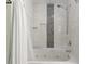 Bathroom featuring a tub with white marble-like tile and a decorative vertical accent line at 4765 Arco Ln, North Charleston, SC 29418