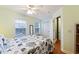 Bedroom features a queen-size bed with seahorse-themed bedding, a ceiling fan, and a closet at 4765 Arco Ln, North Charleston, SC 29418