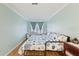 Bedroom features a full bed with blue and white bedding, wood floors, and light blue walls at 4765 Arco Ln, North Charleston, SC 29418