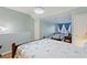Shared bedroom with two beds, light blue walls, and a connecting door to another room at 4765 Arco Ln, North Charleston, SC 29418