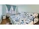 Bedroom featuring a full-size bed with blue bedding, blue curtains, and light blue walls at 4765 Arco Ln, North Charleston, SC 29418