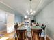 Open concept dining room features modern lighting fixture and hardwood flooring at 4765 Arco Ln, North Charleston, SC 29418