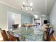 Open concept dining room features modern lighting fixture and hardwood flooring at 4765 Arco Ln, North Charleston, SC 29418