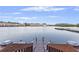 Wooden dock featuring fishing equipment and seating overlooking a serene waterfront at 4765 Arco Ln, North Charleston, SC 29418