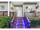 Inviting front entrance featuring a well-lit porch and tasteful landscaping, adding to the home's curb appeal at 4765 Arco Ln, North Charleston, SC 29418