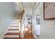Bright foyer with hardwood floors and staircase, seamlessly connecting living spaces at 4765 Arco Ln, North Charleston, SC 29418