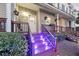 Home exterior featuring a welcoming front porch with custom railings, a light fixture, and step lighting at 4765 Arco Ln, North Charleston, SC 29418