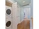 Hallway with hardwood floors and washer/dryer unit at 4765 Arco Ln, North Charleston, SC 29418