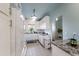 Bright galley kitchen boasts white cabinets and stainless appliances for a modern feel at 4765 Arco Ln, North Charleston, SC 29418