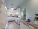 Bright galley kitchen boasts white cabinets and stainless appliances for a modern feel at 4765 Arco Ln, North Charleston, SC 29418