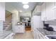 Galley style kitchen with white appliances opens up into a dining area and main living space at 4765 Arco Ln, North Charleston, SC 29418