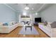 Bright living room boasts hardwood floors, plenty of seating, and access to a patio with sliding glass doors at 4765 Arco Ln, North Charleston, SC 29418