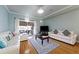 Bright living room boasts hardwood floors, plenty of seating, and access to a patio with sliding glass doors at 4765 Arco Ln, North Charleston, SC 29418