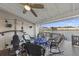 Relax on this covered deck with nice views, a ceiling fan, and workout equipment at 4765 Arco Ln, North Charleston, SC 29418