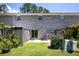 Home's backyard shows brick facade, lawn, privacy fence and small patio, perfect for outdoor enjoyment at 507 Stinson Dr # E8, Charleston, SC 29407