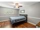 Comfortable bedroom features a queen bed, hardwood floors, and a bright window, creating a peaceful retreat at 507 Stinson Dr # E8, Charleston, SC 29407