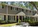 Exterior of the townhome showing a combination of gray siding and brick with black shutters and well-maintained landscaping at 507 Stinson Dr # E8, Charleston, SC 29407