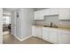 A basic kitchen with white cabinets, neutral countertops and tile floors offering functionality and ample storage space at 507 Stinson Dr # E8, Charleston, SC 29407